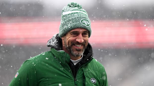 Aaron Rodgers smiles as snow falls around him